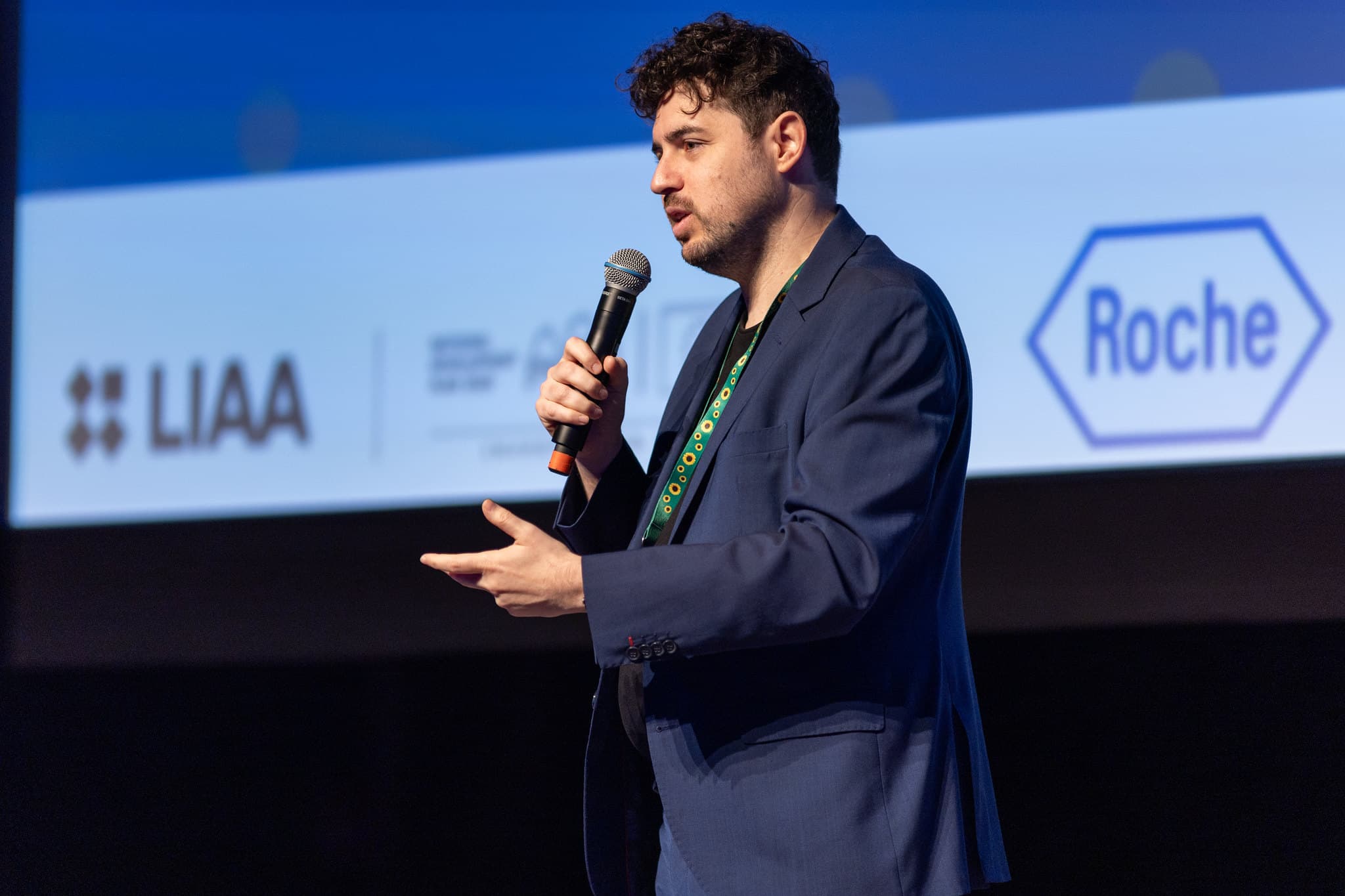 Roi Sternin speaking on stage at an international conference